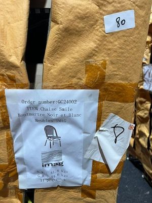 a piece of paper taped to the back of a chair