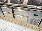 several stainless steel stoves and ovens in a commercial kitchen