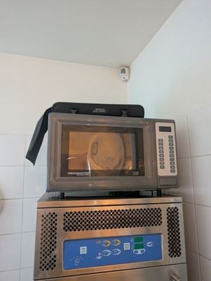 deux micro-ondes empilés l'un sur l'autre dans une cuisine