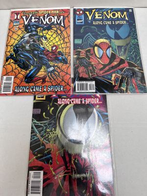two venom comics are on display on a table