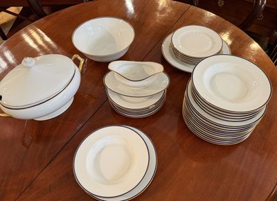 a lot of plates and bowls on the table