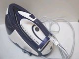 a blue and white steam iron sitting on a white surface