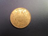 an image of a gold coin on a black surface