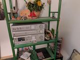 a bed with a green frame and a book shelf on top of it