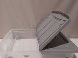a plastic box with a lid that is open on a table