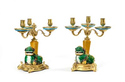 pair of green and gold candelabs with a frog on a pedestal