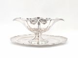an image of a silver plate with a glass bowl on it