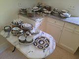 many plates and bowls on the table in the kitchen