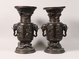 two vases sitting next to each other on a table