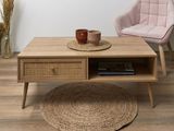 a coffee table with a basket on it and a chair in the background