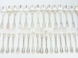 a lot of silver spoons and forks on the table