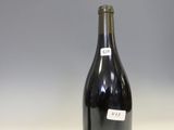 a bottle of wine sitting on a counter in a kitchen