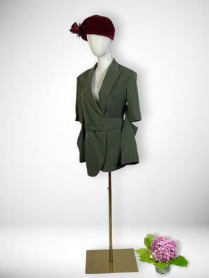 mannequin with green jacket and red beret on display