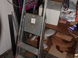 a ladder that is leaning against a wall in a room