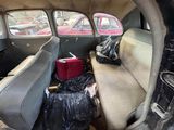a car that has a lot of trash in the back of it