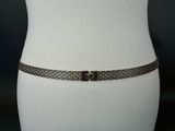 a close up of a mannequin torso with a chain belt