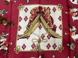 an image of a red table cloth with a picture of a couple of horses