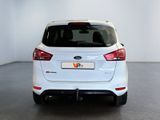 the rear end of a white ford focus parked in a white room