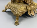 a gold clock sitting on top of a table