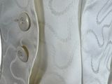 a close up of a white jacket with buttons on it