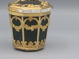 a black and gold container with a gold decoration