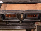 a wooden stove with a drawer on top of it