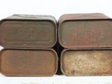 three metal containers are stacked on top of each other on a table