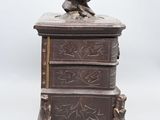a small wooden box with a bird on top