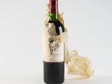 a bottle of wine that is sitting next to a piece of paper