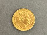 a close up of a gold coin on a gray surface