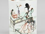 an image of a cup with a woman sitting at a table and another woman sitting at a table