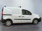 a white van with a black stripe parked in a room