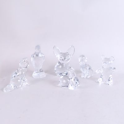 five crystal figurines of mice on a white surface