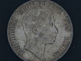 une vieille pièce d'argent sur laquelle figure le profil d'une femme