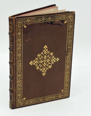 an old book with a golden cross on the front cover