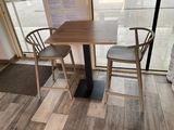 two chairs and a table in the corner of a room