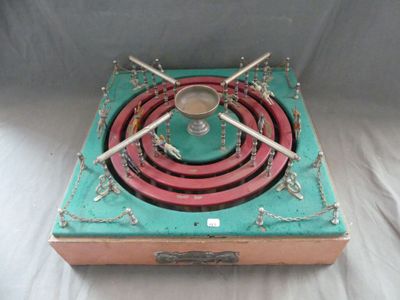 un réchaud vert et rouge muni d'un brûleur en métal