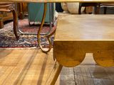 a wooden table with a metal frame on it in the middle of a room