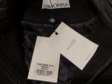 a close up of a black jacket with a tag on it