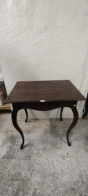 une petite table avec un plateau en bois sur un sol en béton