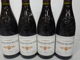 four bottles of wine are lined up on a table