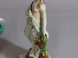 two figurines of a man and a woman on a table