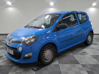 the small blue car is parked on a checkered floor