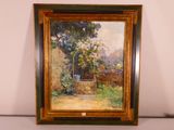 an oil painting of a garden scene in a frame on a table