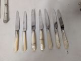 several knives and knives are lined up on a table