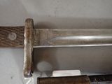 a close up of a knife with a wooden handle