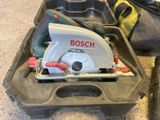 a bosch circular saw in a case with tools in it