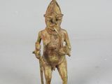 a small statue of a man holding a stick