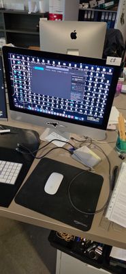 a desk with a computer and a keyboard on it