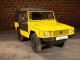 a yellow jeep that is parked in front of a brick wall